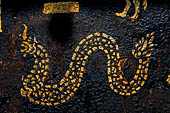 Wat Xieng Thong temple in Luang Prabang, Laos. Detail of the  intricate gold stencilling on black lacquer that decorate the walls of the sim. 